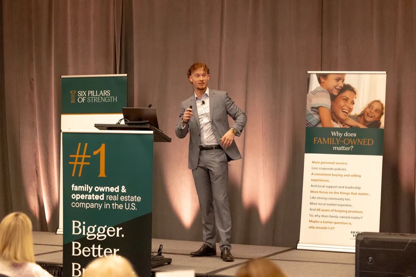Rider Harris speaking on stage at an AI workshop